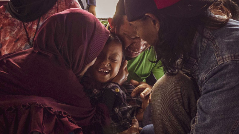 Rizky, Indonesian boy and his father and grandmother