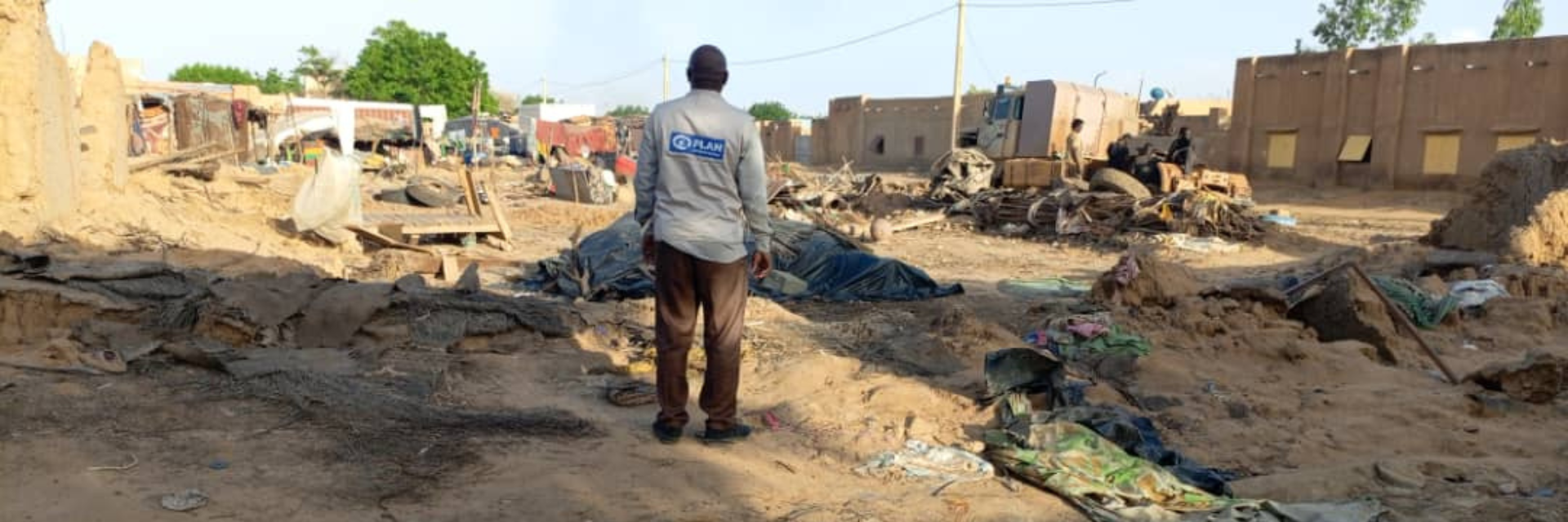 Plan international worker standing in the floods