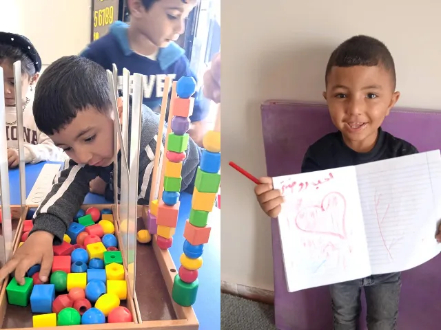 A boy plays with blocks and another boy holds up a picture of a heart he drew