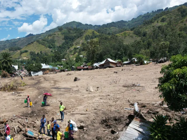 People gather to assess damage of landslide