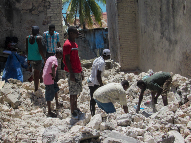 People searching through the rubble after the earthquake in Haiti