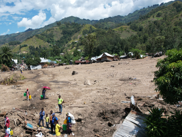 People gather to assess damage of landslide