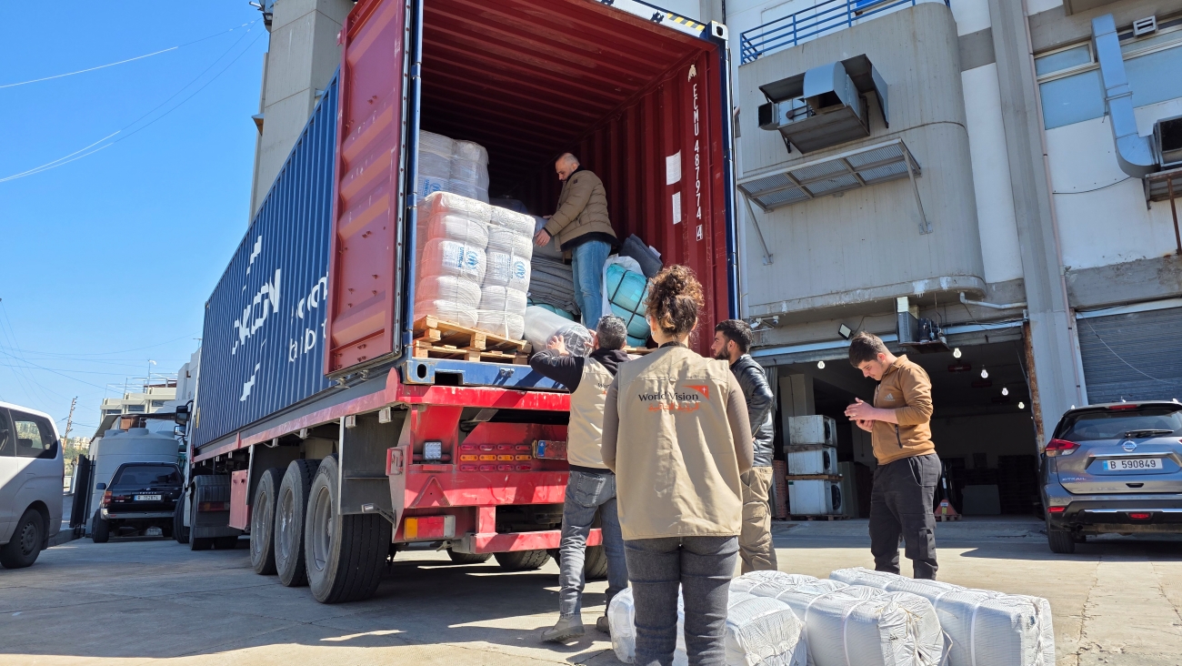 Humanitarian workers unload supplies from a truck in Lebanon