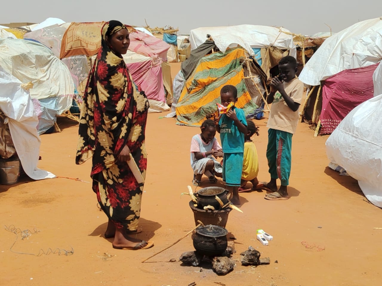 A woman and her children in a displacement camp